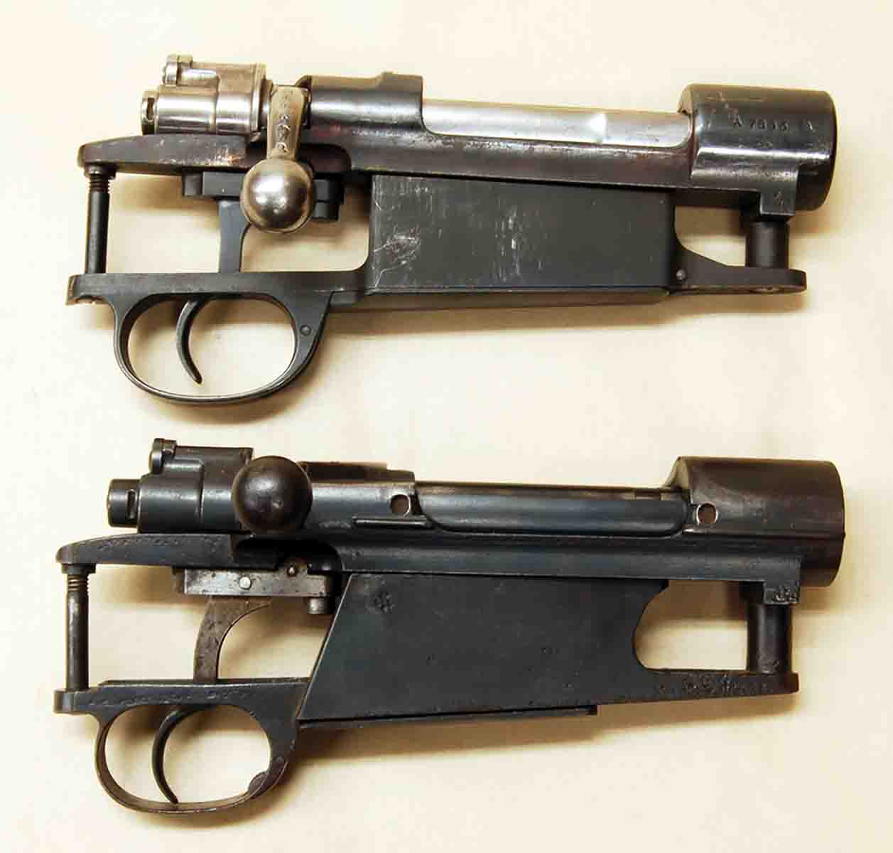 The 1909 Argentine Mauser 98 action (top) has a conventional magazine box, while the Siamese Mauser (bottom) uses an odd-looking “slant-box” magazine necessary for its rimmed cartridges.